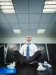 businessman doing yoga in office
