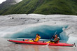 Happy young couple kayaking in Valdez glacial lake