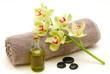 massage oil and orchids on towel
