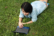A smiling young girl with laptop outdoors A smiling young girl with laptop outdoors