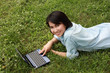 A smiling young girl with laptop outdoors A smiling young girl with laptop outdoors