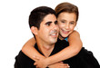 A beautiful girl hugging a young man with her arms around him