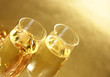Champagne glasses on golden background