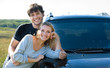 couple standing near the new car