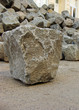 one 1 cobble stone laying in front of stack one 1 cobble stone laying in front of stack