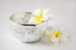 silver water dipper with flower