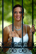 Photo: Bride portrait on a garden fence, looking and waiting Bride portrait on a garden fence, looking and waiting