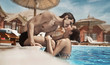 Young couple kissing in a swimming pool