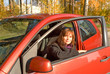 Young women in the cabin of her red car