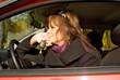 Young women with key in the cabin of her red car