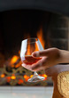 Resting at the burning fireplace fire with a glass of cognac
