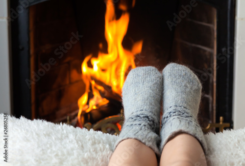 Photo: Children's feet are heated in the fireplace Children's feet are heated in the fireplace