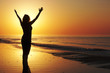 Woman with open arms at the sunset Woman with open arms at the sunset