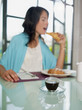 woman having breakfast with espresso coffee
