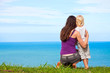 Mother and child looking at a beautiful ocean view