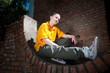 Teenage hip-hop girl on red brick wall