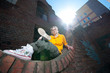 Teenage hip-hop girl on red brick wall