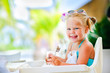 little smiling girl have a breakfast little smiling girl have a breakfast