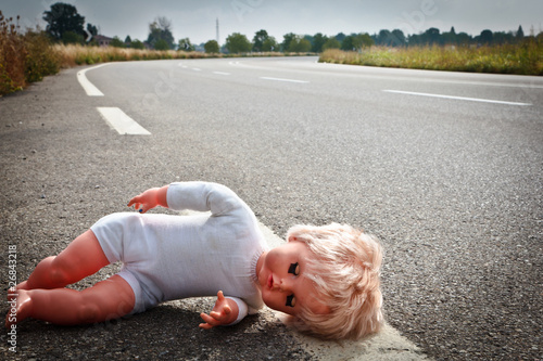 Photo: doll leave on a highway lane doll leave on a highway lane