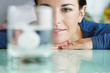 woman looking at aspirin in glass of water
