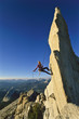 Female rock climber rappelling.