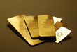 Some gold bars on a reflective surface