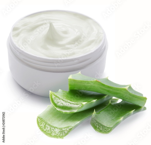 Photo: Opened plastic container with cream and aloe. Opened plastic container with cream and aloe.