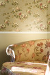 Photo : part of vintage chair with flowers standing near the wall part of vintage chair with flowers standing near the wall