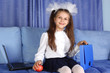 schoolgirl girl with laptop, backpack and red apple in sofa schoolgirl girl with laptop, backpack and red apple in sofa
