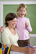 Photo: Teacher teaching young student in classroom Teacher teaching young student in classroom