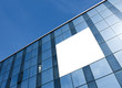 transparent glass wall with blank placard of skyscraper