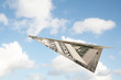 dollar paper plane in the sky