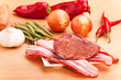 rohes Fleisch und Speckstreifen auf einem Holztisch rohes Fleisch und Speckstreifen auf einem Holztisch