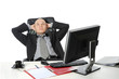 Photo: Young businessman sitting at his desk in the office. Young businessman sitting at his desk in the office.