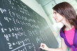 pretty young college student writing on the chalkboard/blackboar