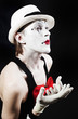 Mime with red bow ina white hat and striped gloves Mime with red bow ina white hat and striped gloves