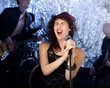 Beautiful rock singer with her band in the background