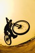 Silhouette Of A Cyclist Against A Yellow Sky