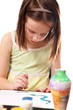 Little girl paints with watercolors