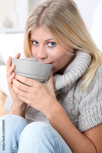 Photo: Beautiful woman drinking hot drink in winter Beautiful woman drinking hot drink in winter