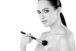 woman doing her makeup