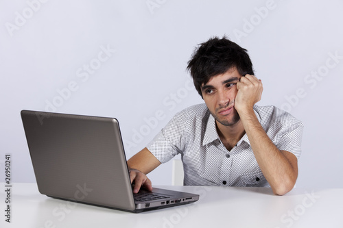 Photo: Young working with his laptop Young working with his laptop