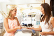 Photo: Female Sales Assistant At Checkout Of Clothing Store With Custom Female Sales Assistant At Checkout Of Clothing Store With Custom