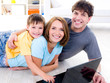Family with son on the floor with laptop