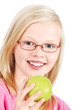 A cheerful and cute blond girl eating apple
