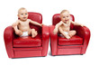 Twin sisters on armchairs.