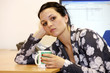 Young Woman In Office Drinking Coffee. Model Released