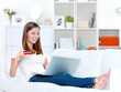woman holding credit card looks in laptop woman holding credit card looks in laptop