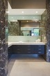 Storage units and mirror in bathroom of California home