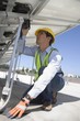 Maintenance worker adjusting solar panel in Los Angeles, California